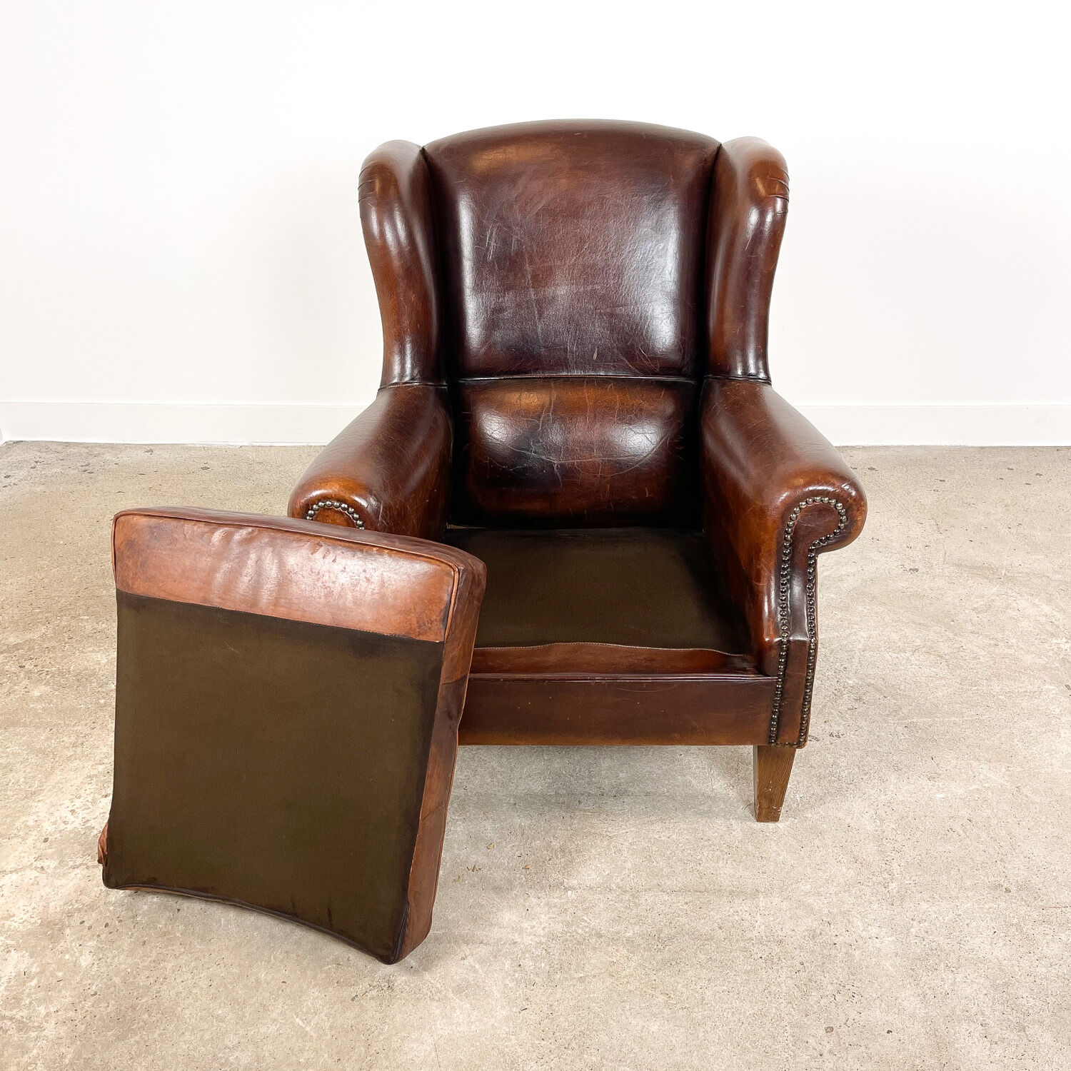 Vintage dark brown sheep leather wingback armchair