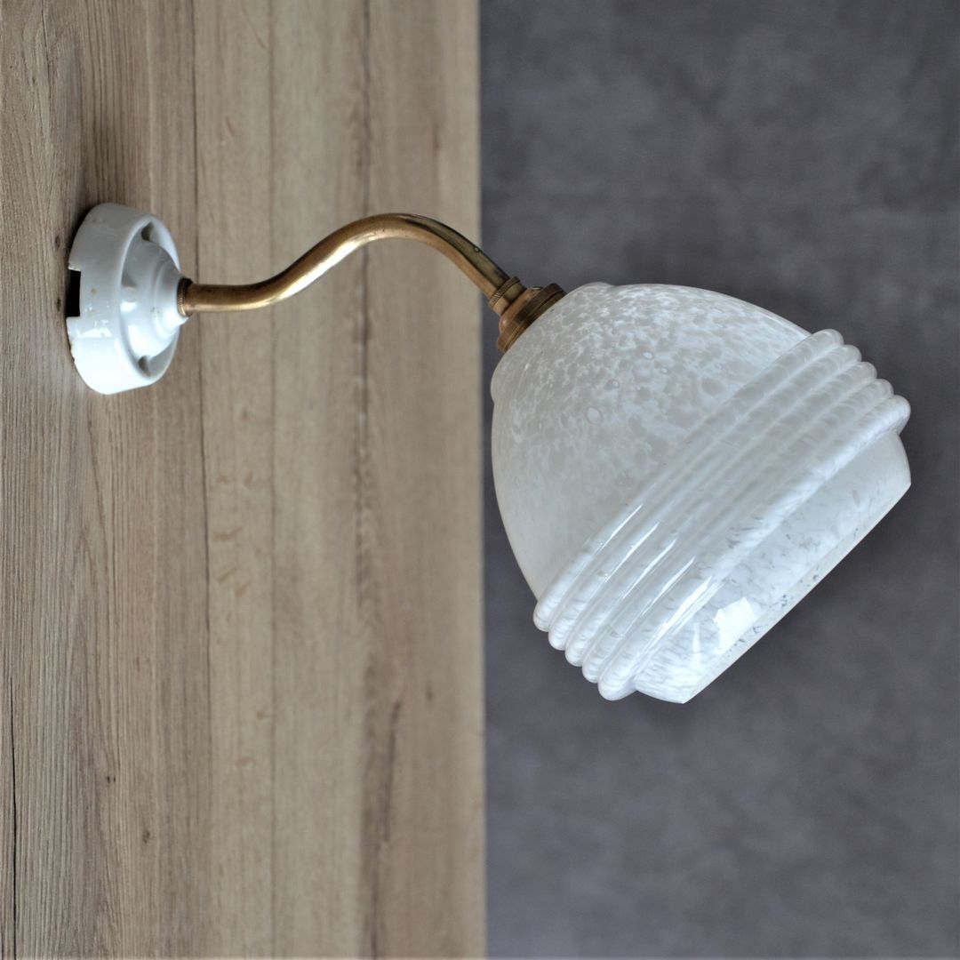 White Clichy glass globe wall light, porcelain support and gooseneck stem in brass