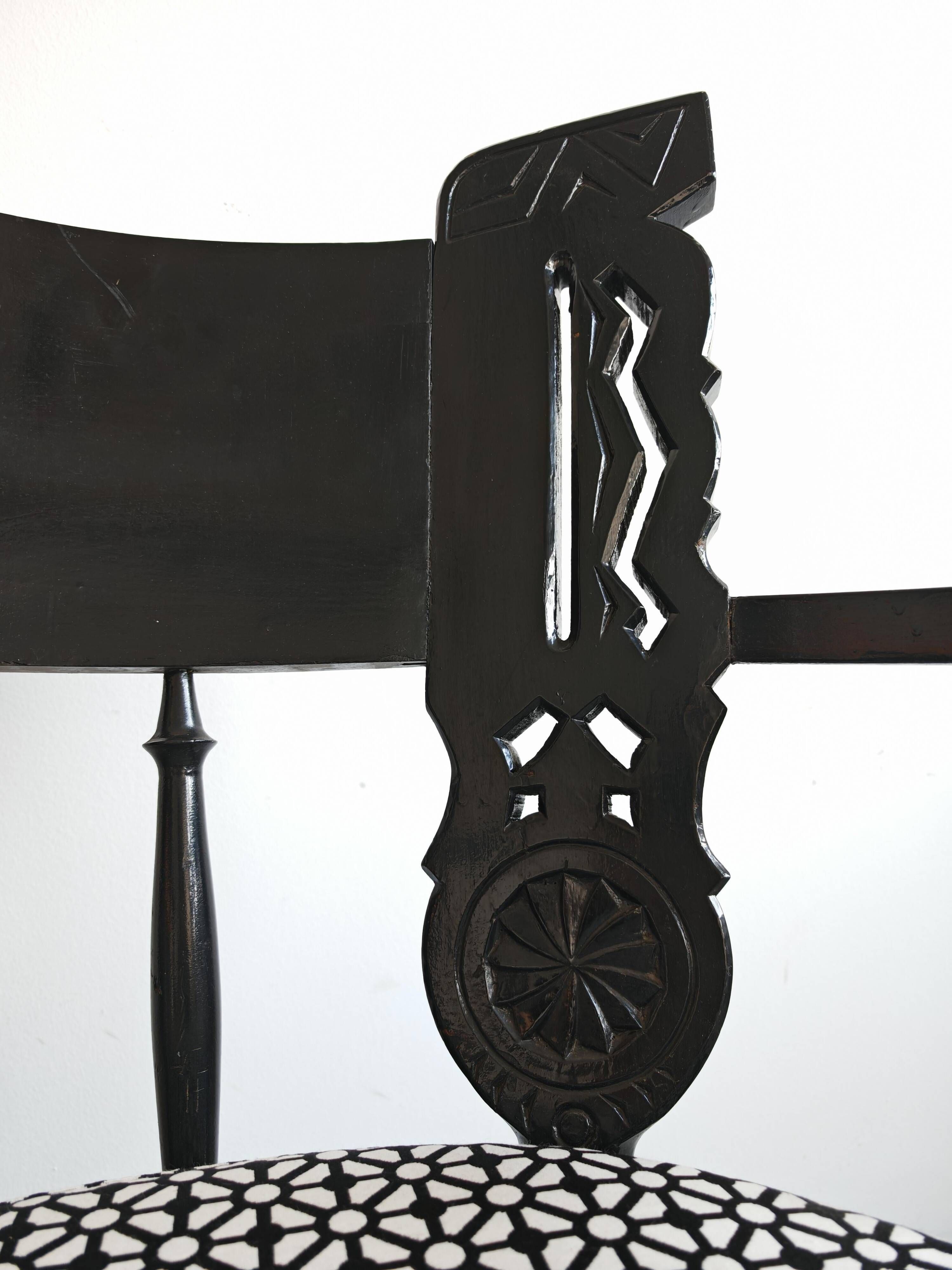 Pair of antique hand-carved armchairs in black lacquer from the 1920s.