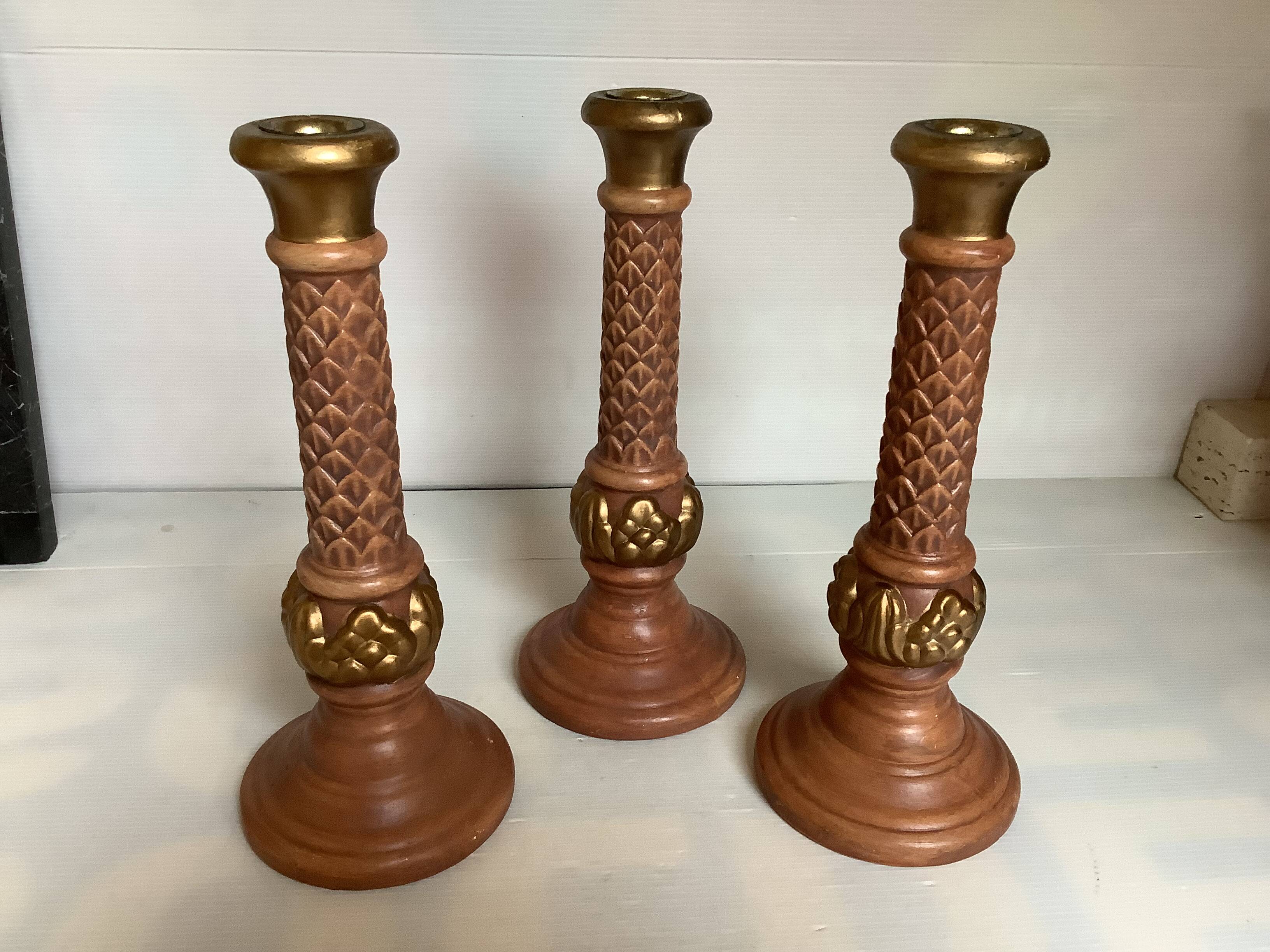 Trio of large brown and gold candlesticks