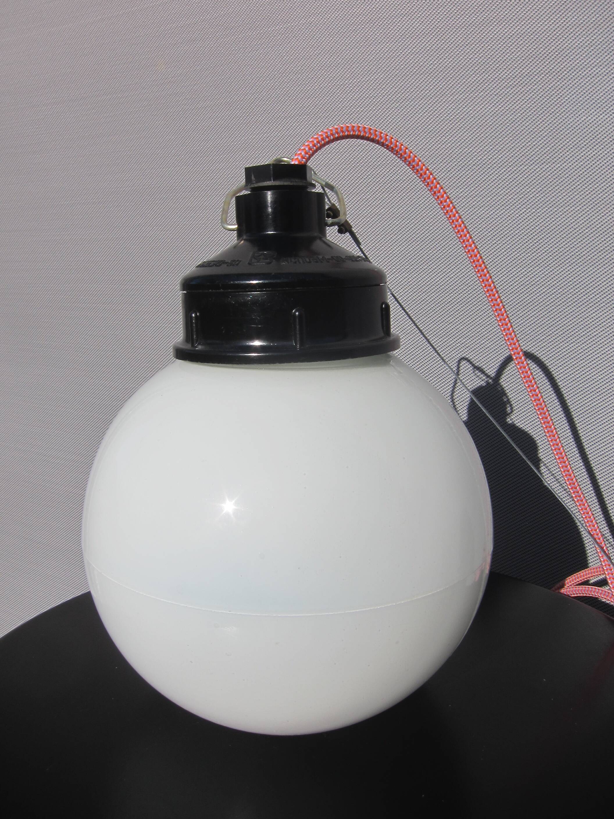 Trio of opal glass and bakelite globe pendant lights