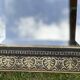 Bevelled mirror from the 19th century with gold and black palmettes.