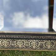 Bevelled mirror from the 19th century with gold and black palmettes.
