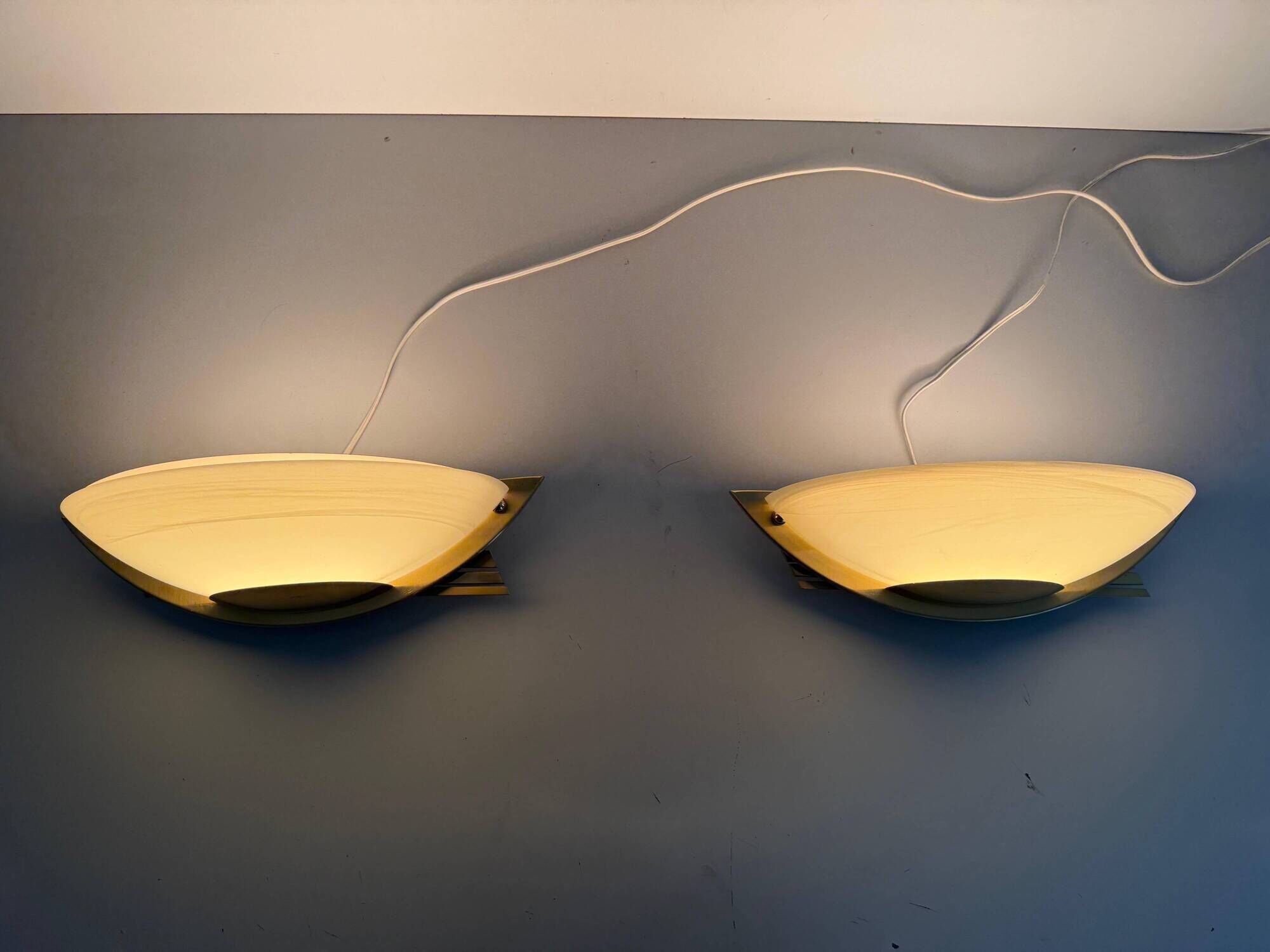 Pair of brass and glass wall lights from the Spage era, 1980, Germany.