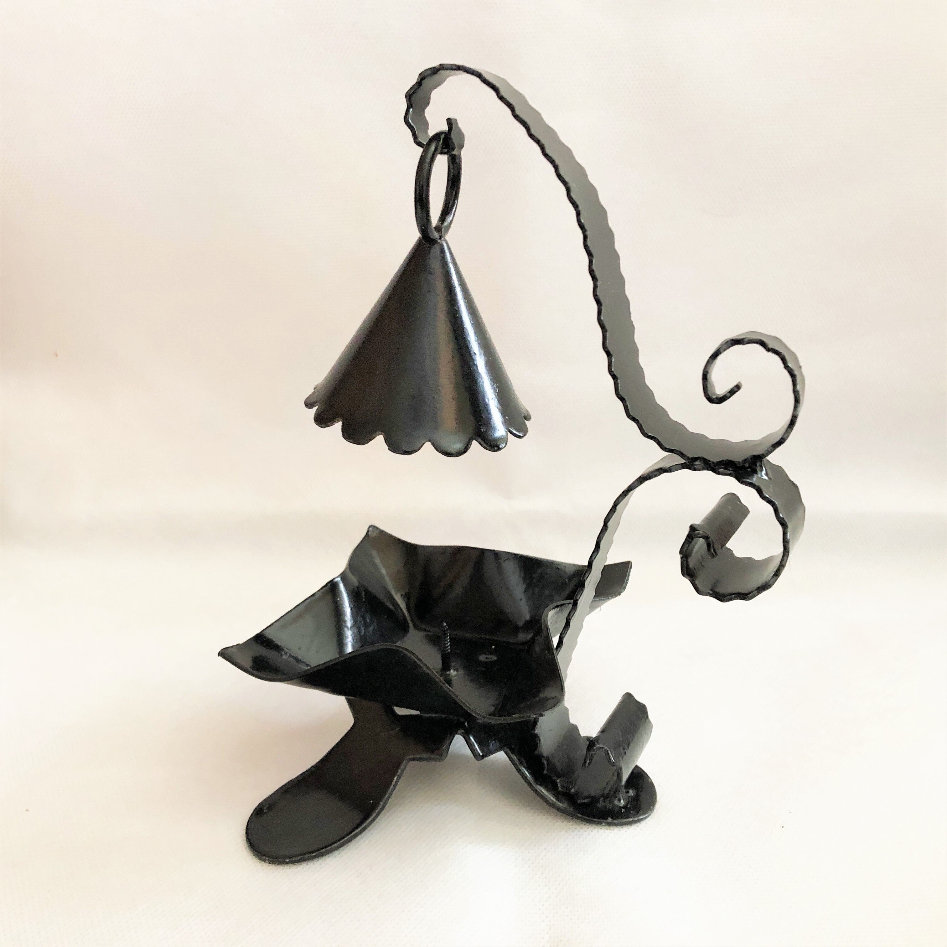 Handcrafted black wrought iron candle holder with its vintage extinguisher