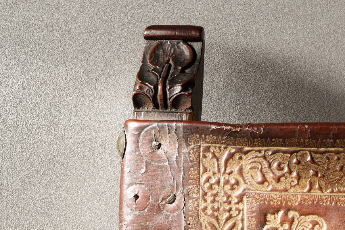 Antique armchair in walnut and studded leather, 17th century