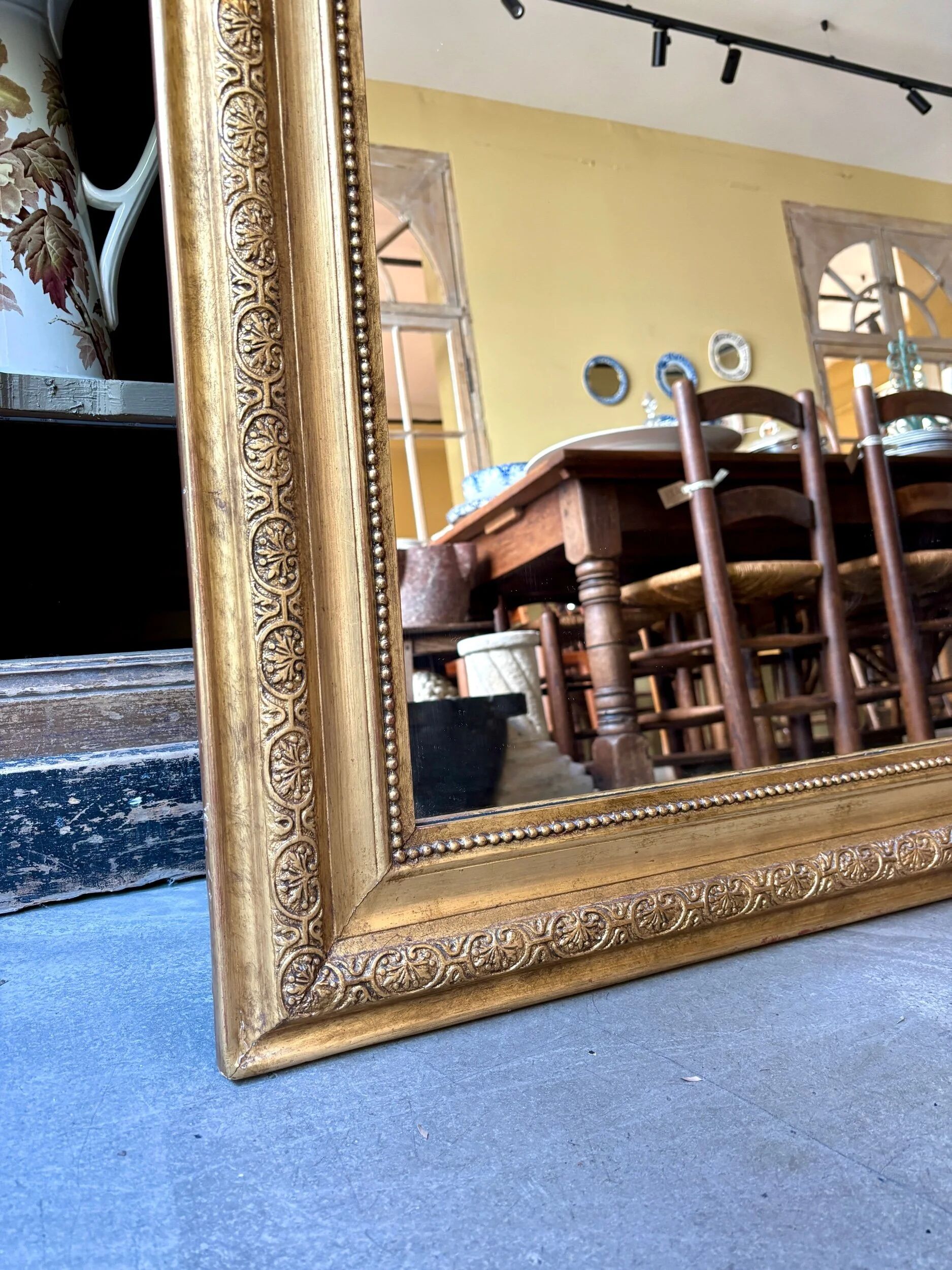 Gold sculpted and moulded stucco trumeau mirror 113 x 78 cm