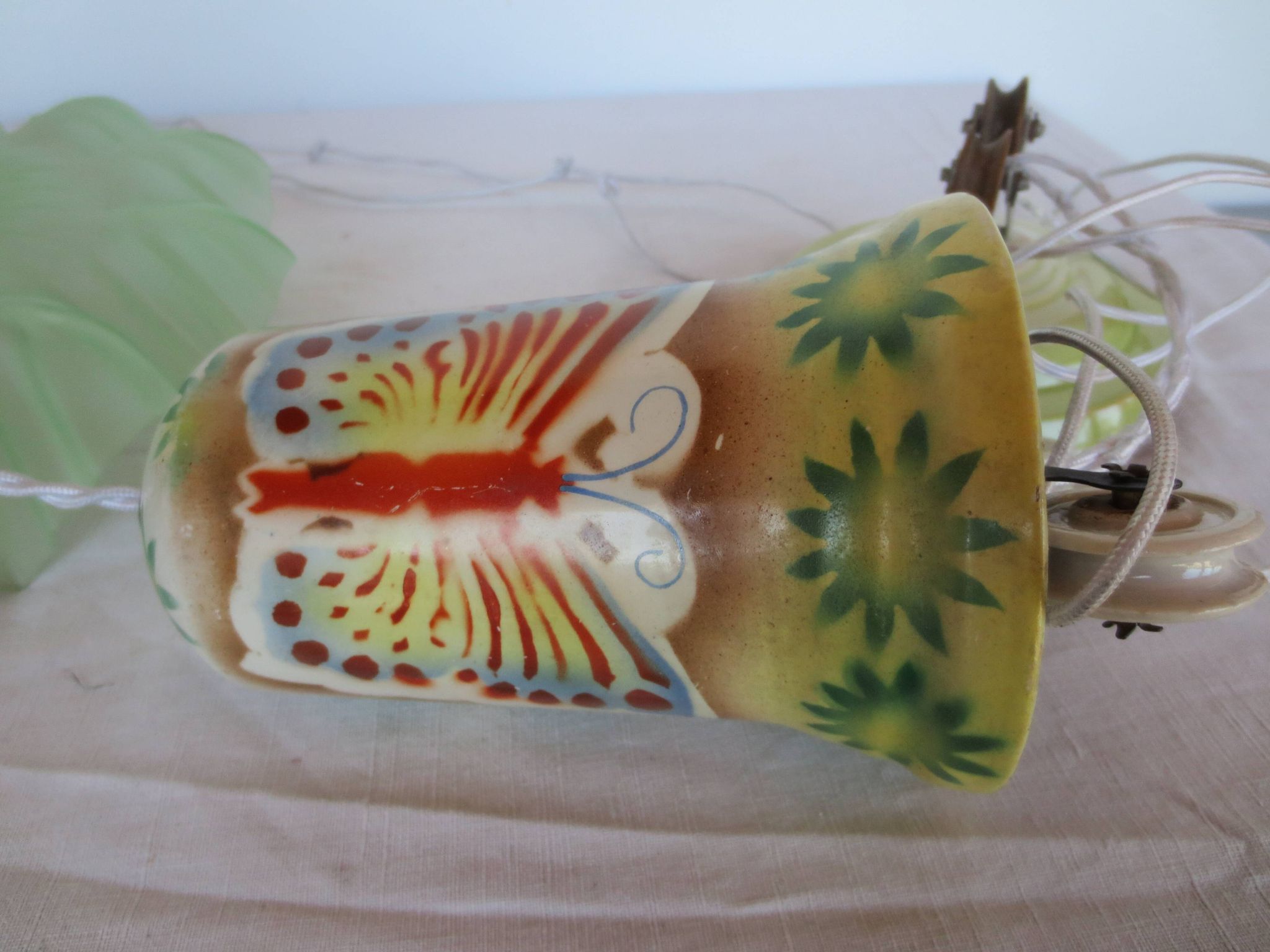 "Very old light fixture" with a "rise and fall" counterweight adorned with butterflies.