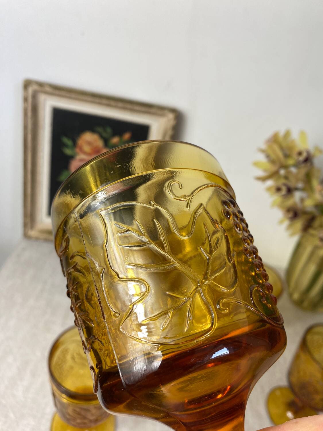Six amber-colored stemmed glasses