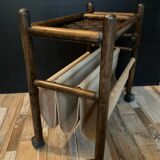 Vintage rattan magazine rack on wheels
