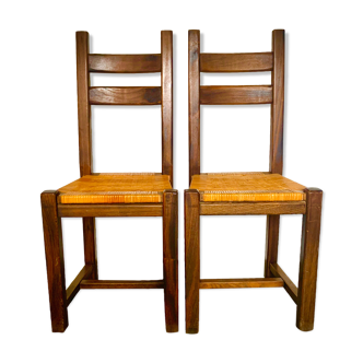 Two brutalist chairs with rattan caning