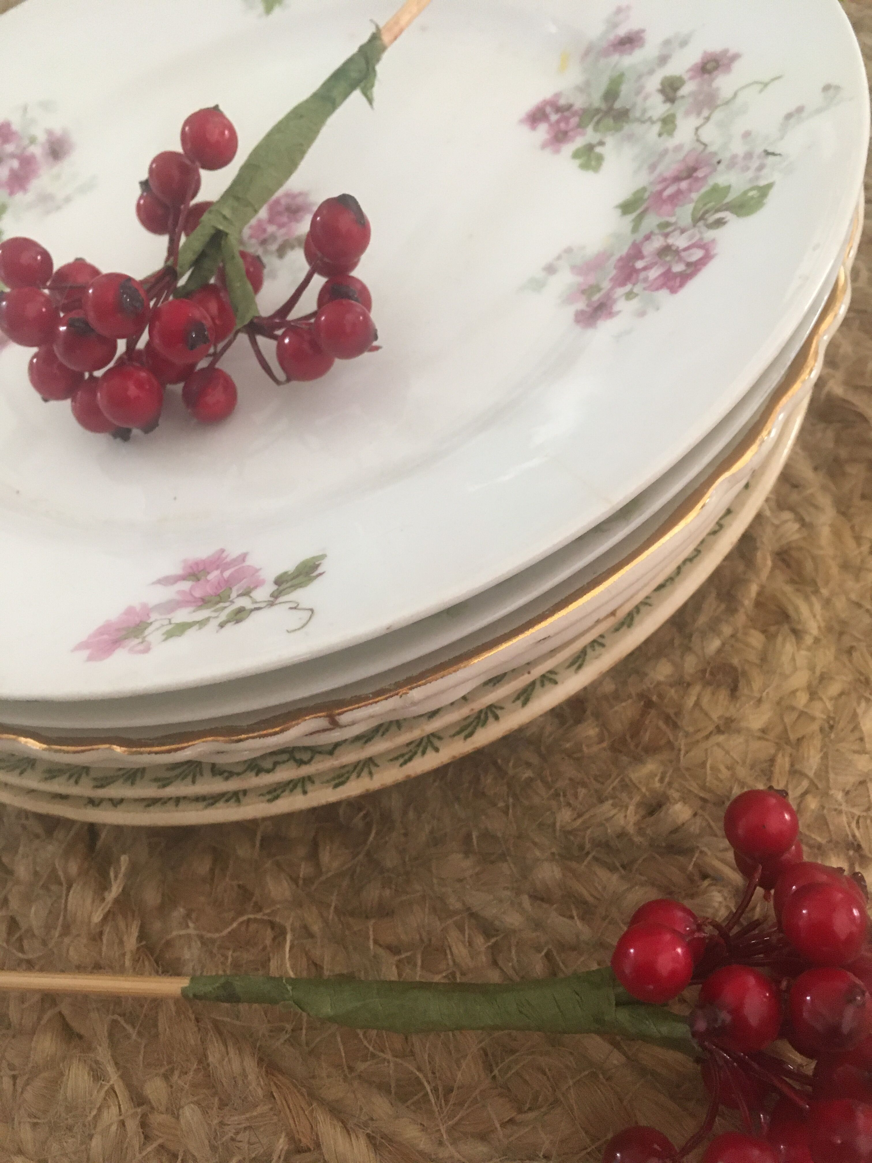 Flat old plates mismatched with flowers