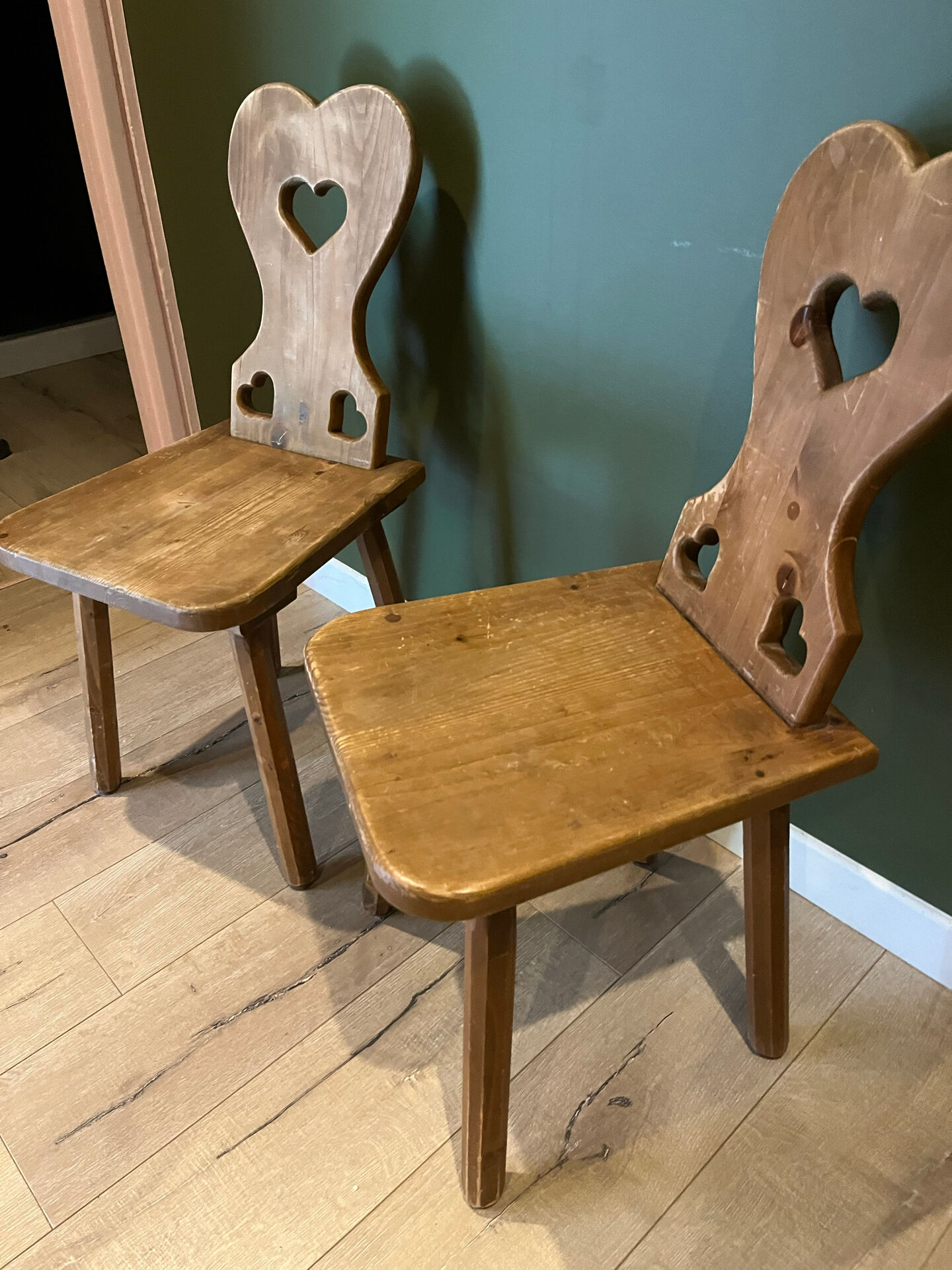 Pair of vintage wooden chairs in alpine chalet style.