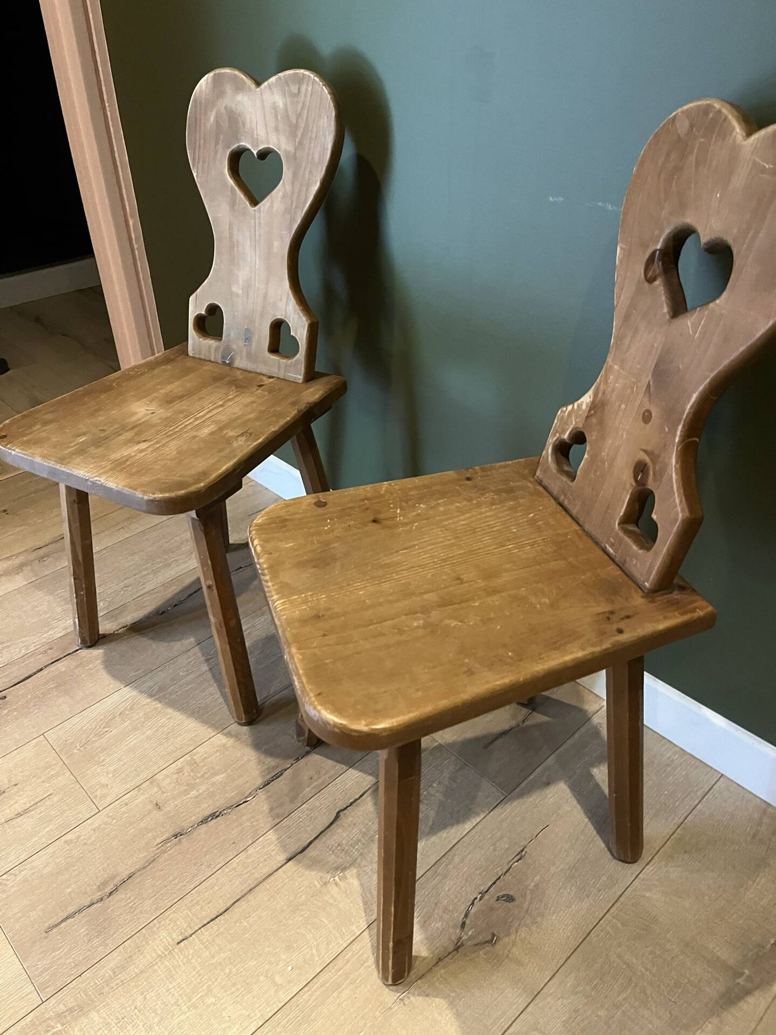 Pair of vintage wooden chairs in alpine chalet style.