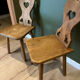 Pair of vintage wooden chairs in alpine chalet style.