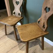 Pair of vintage wooden chairs in alpine chalet style.