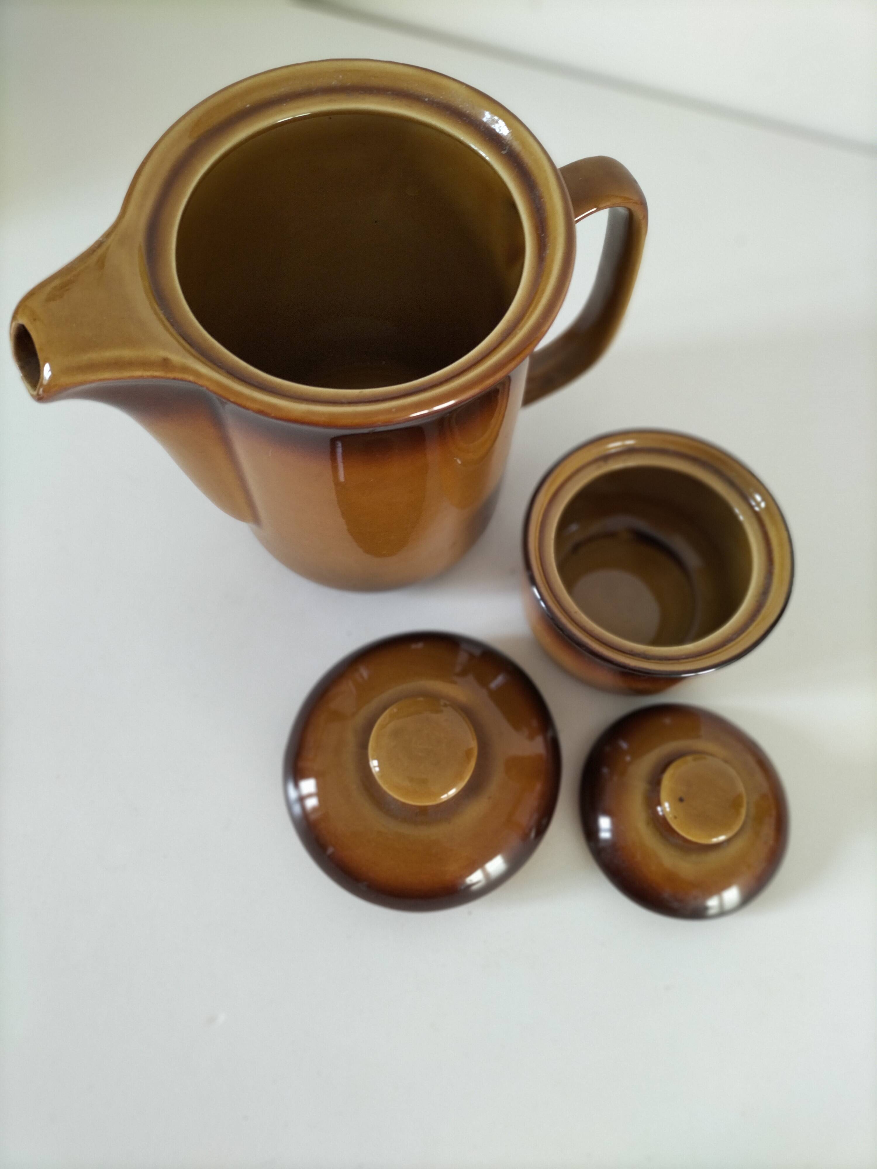 Coffee pot and sugar bowl in glazed stoneware, deep brown glazes.