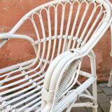 Two white rattan armchairs