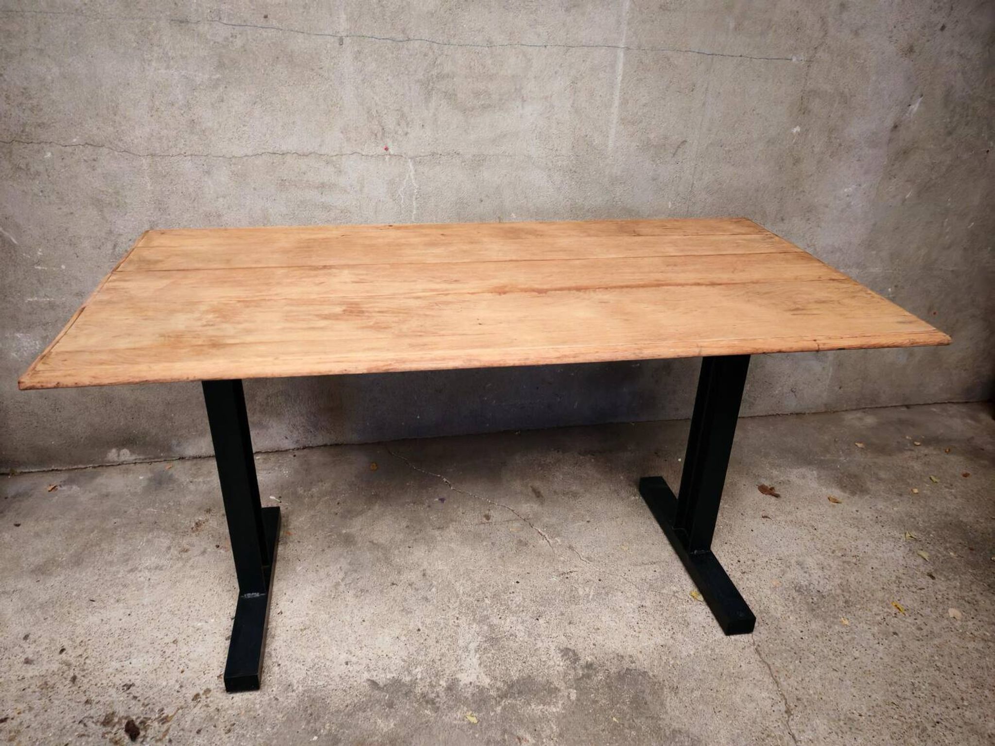 Unique wooden table with metal industrial legs.