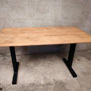 Unique wooden table with metal industrial legs.
