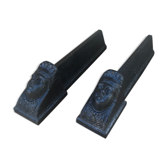 Old pair of chimney caterpillars shape of the head of a woman in iron