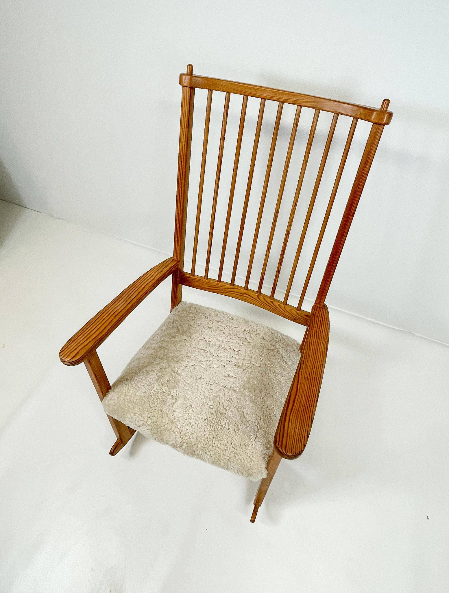 Mid-century rocking chair in pine and sheepskin by Yngve Ekström, Sweden.