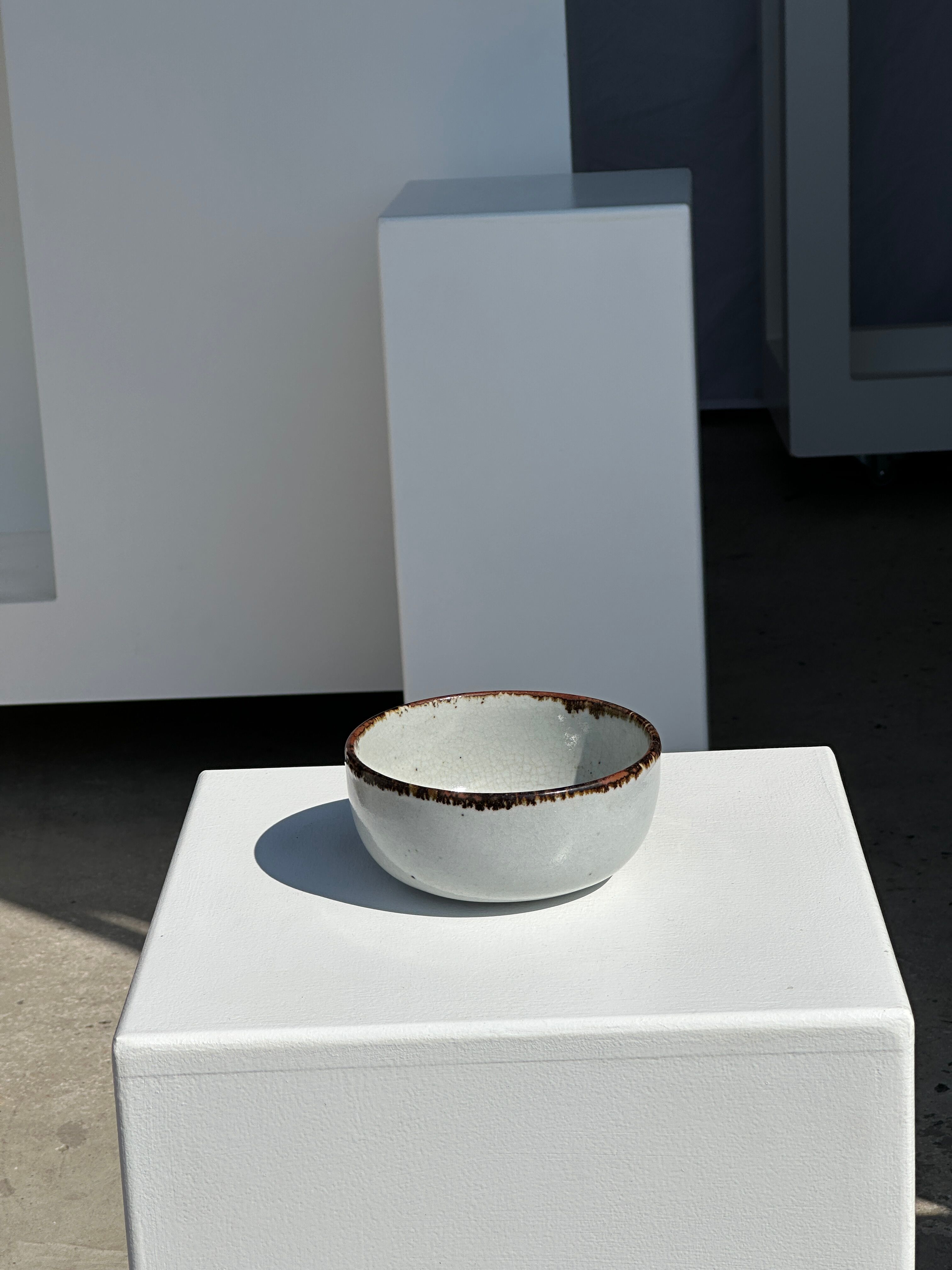 Small white glazed ceramic bowl black edges