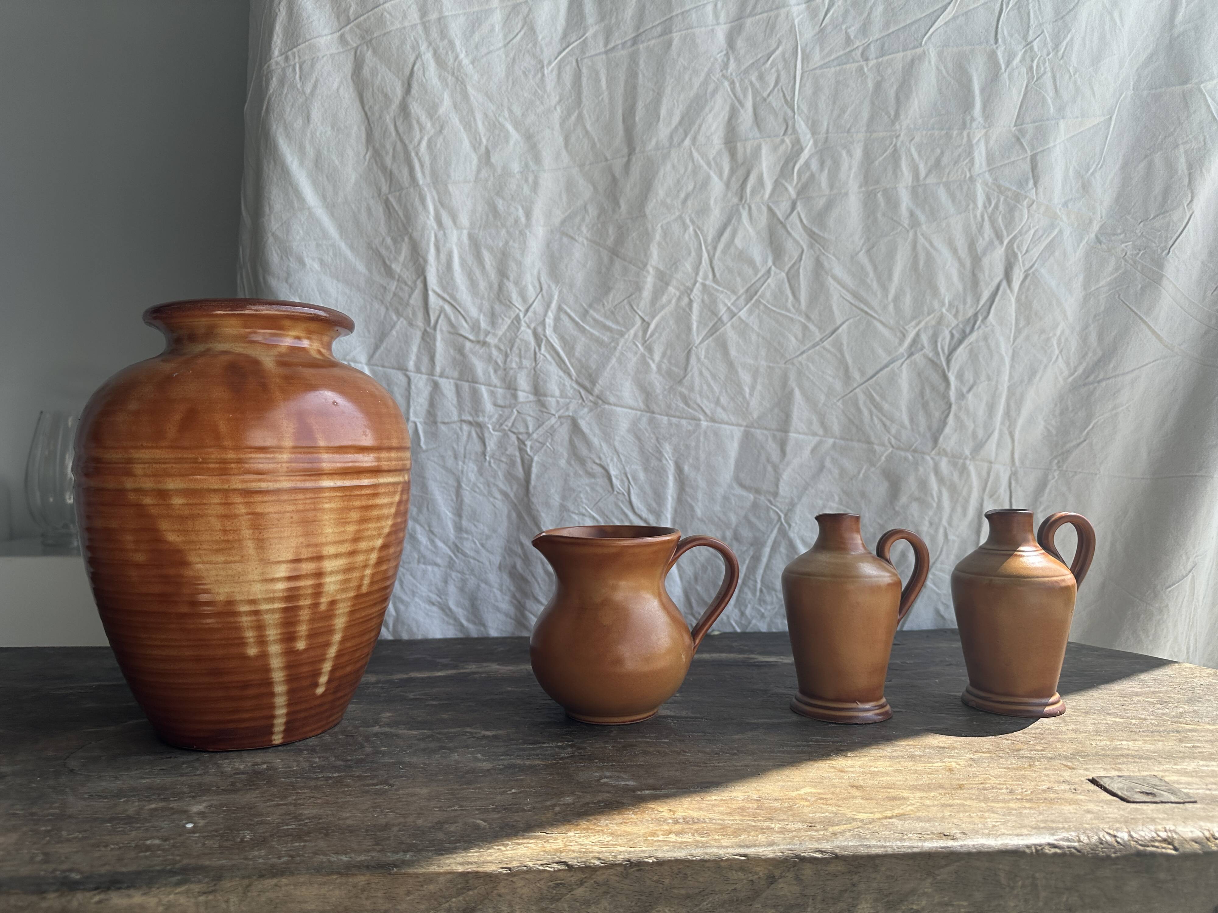 Pair of mini orange stoneware pitchers