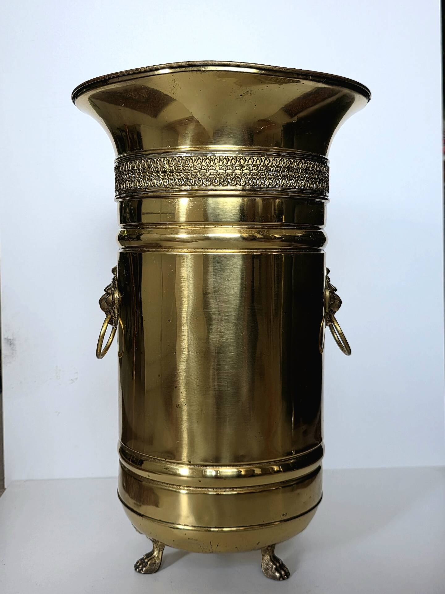 Hollywood Regency style umbrella stand, brass finish and lio pattern.