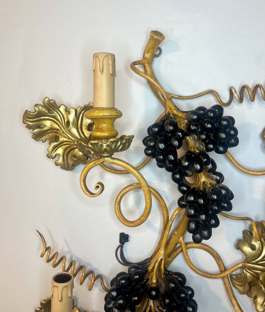 Large pair of wall sconces with vine decorations.