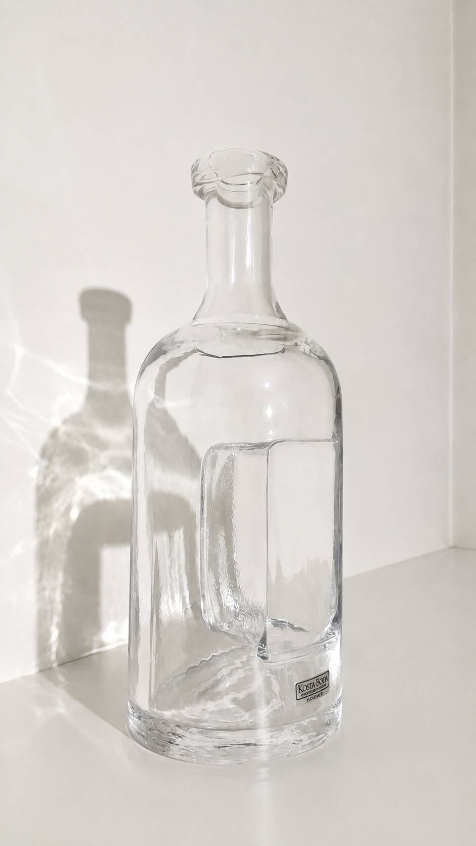 Kosta Boda carafe in blown glass 26 cm with sculptural imprint • Sweden