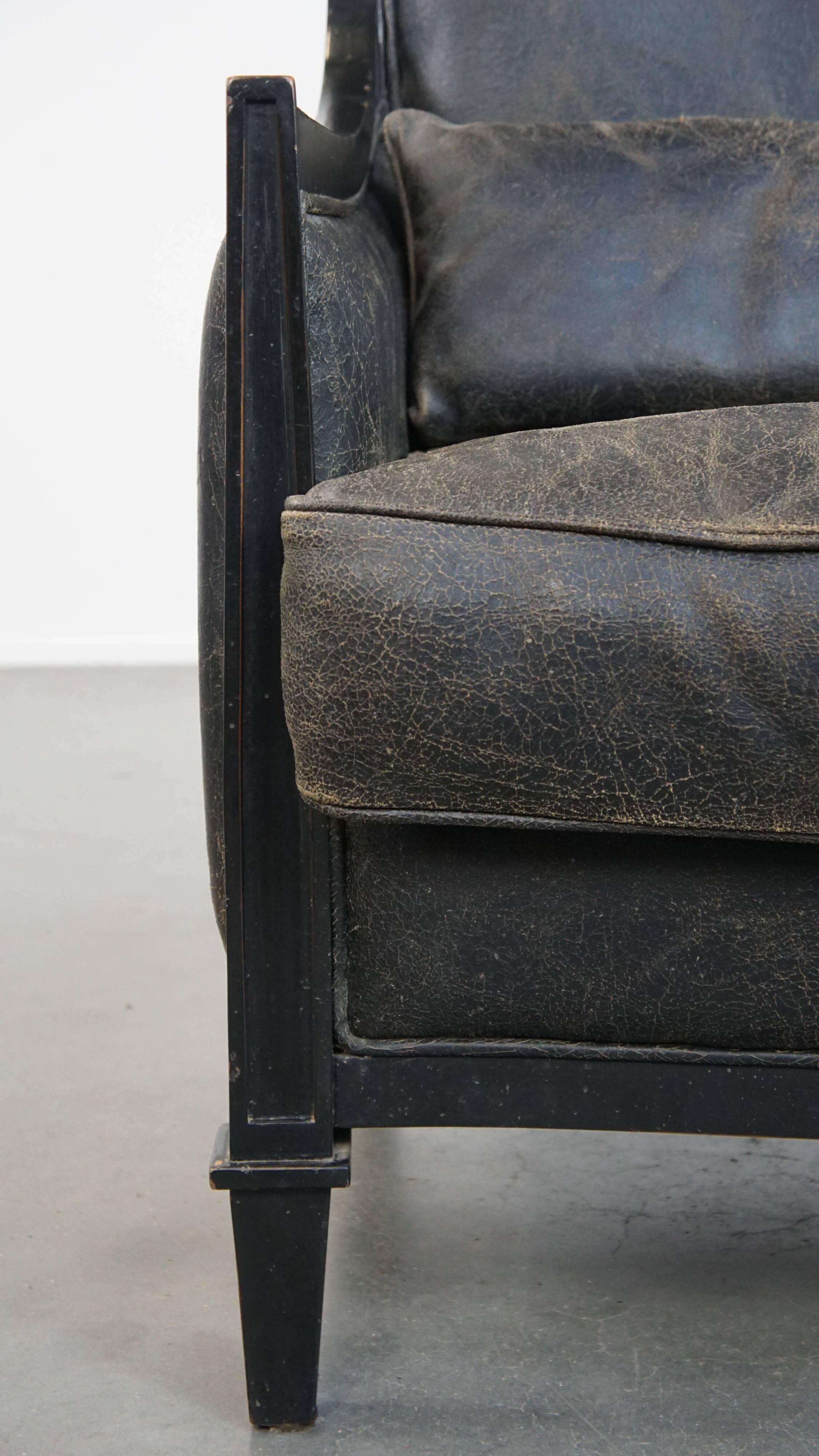 Armchair in black cowhide leather and wood with an Art Deco design