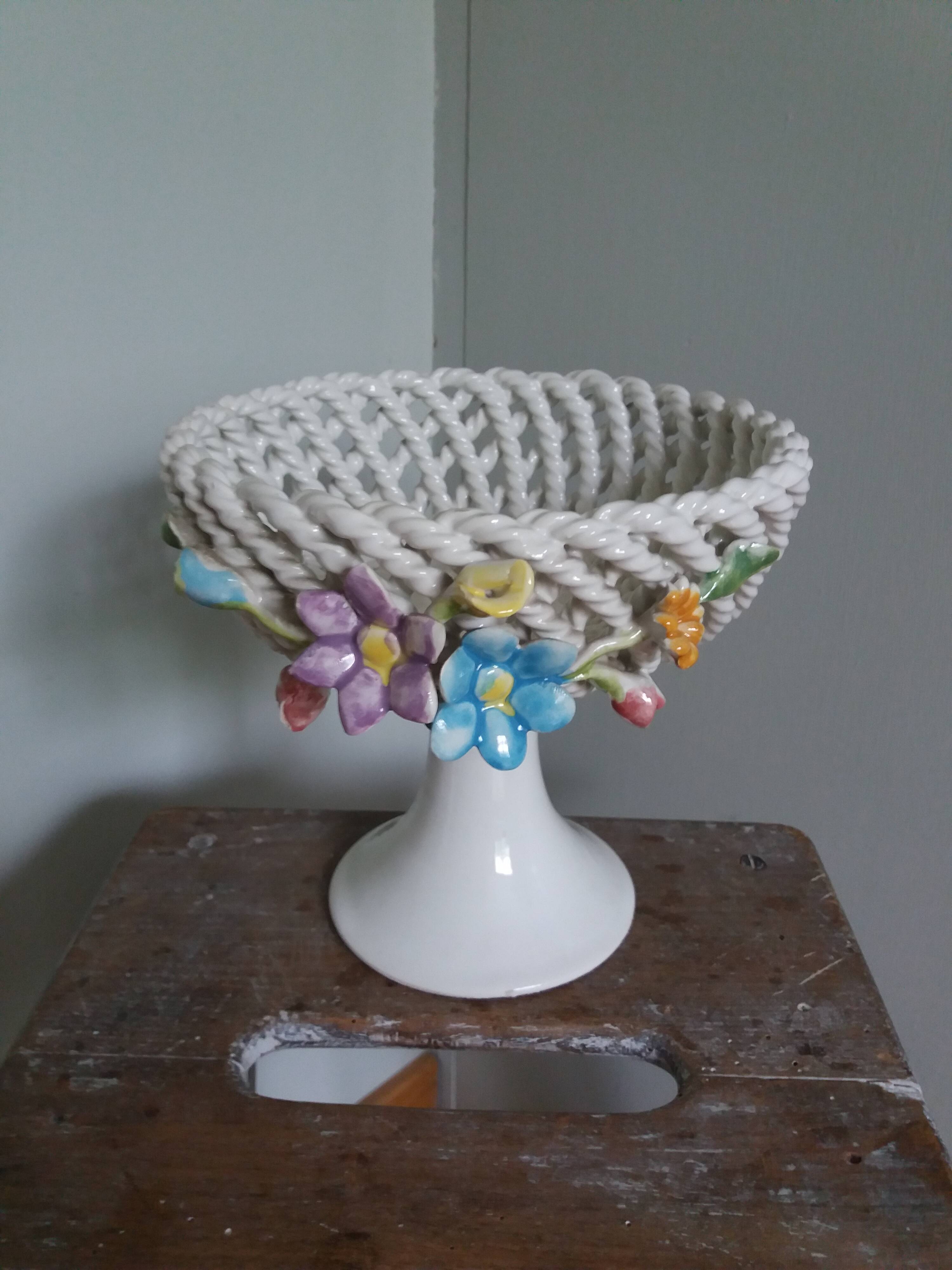 Cup on woven ceramic base with slip flowers