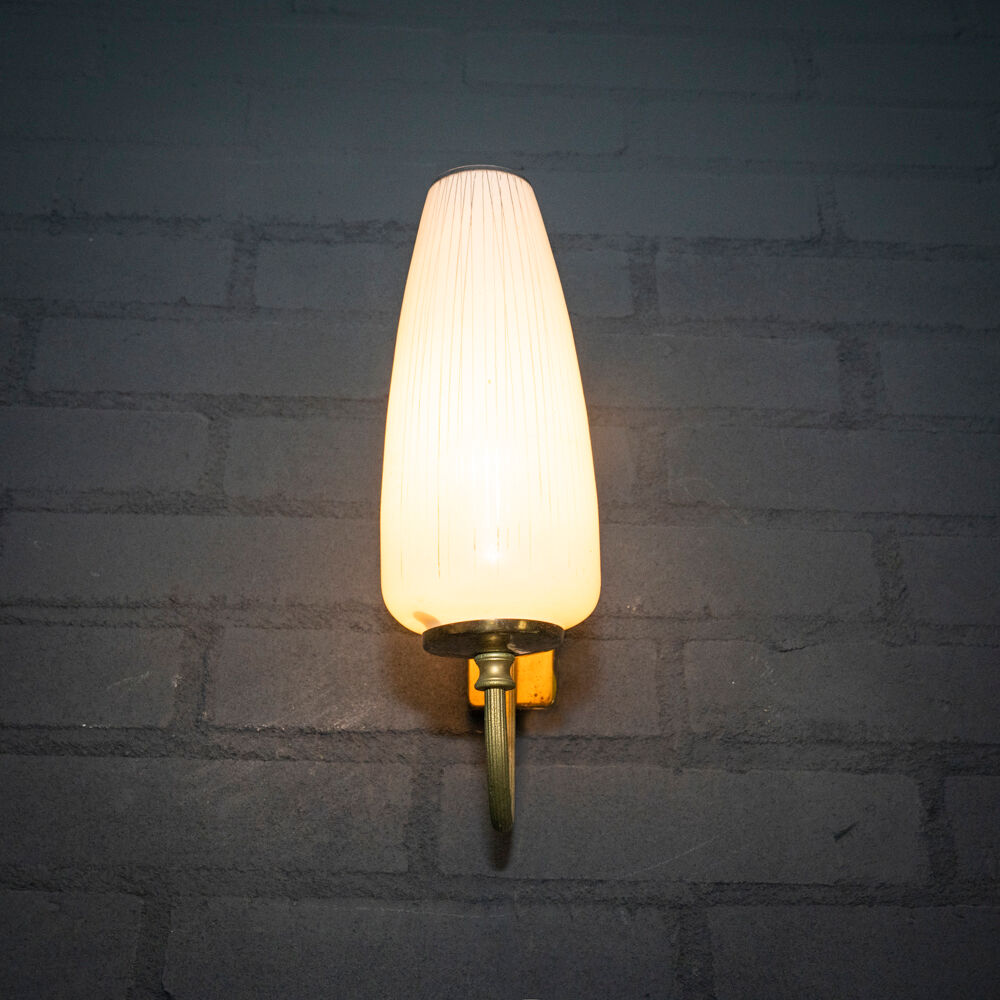 Ornate wall lamp made of milk glass and brass