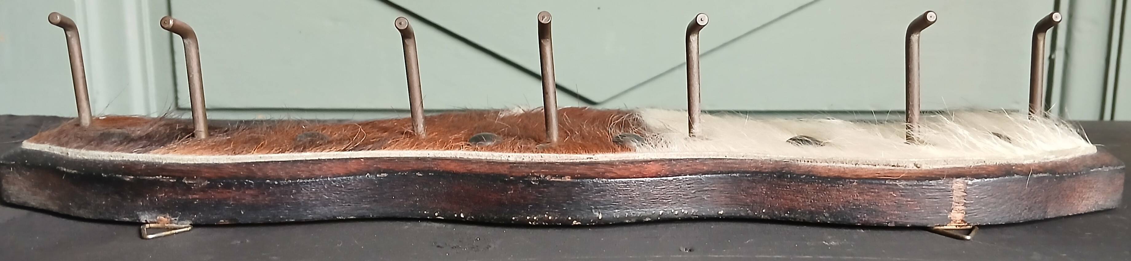 Wooden coat rack, nails & cowhide