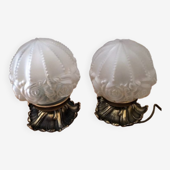 Pair of art deco wall lights with bronze feet and molded glass globes. rose patterns