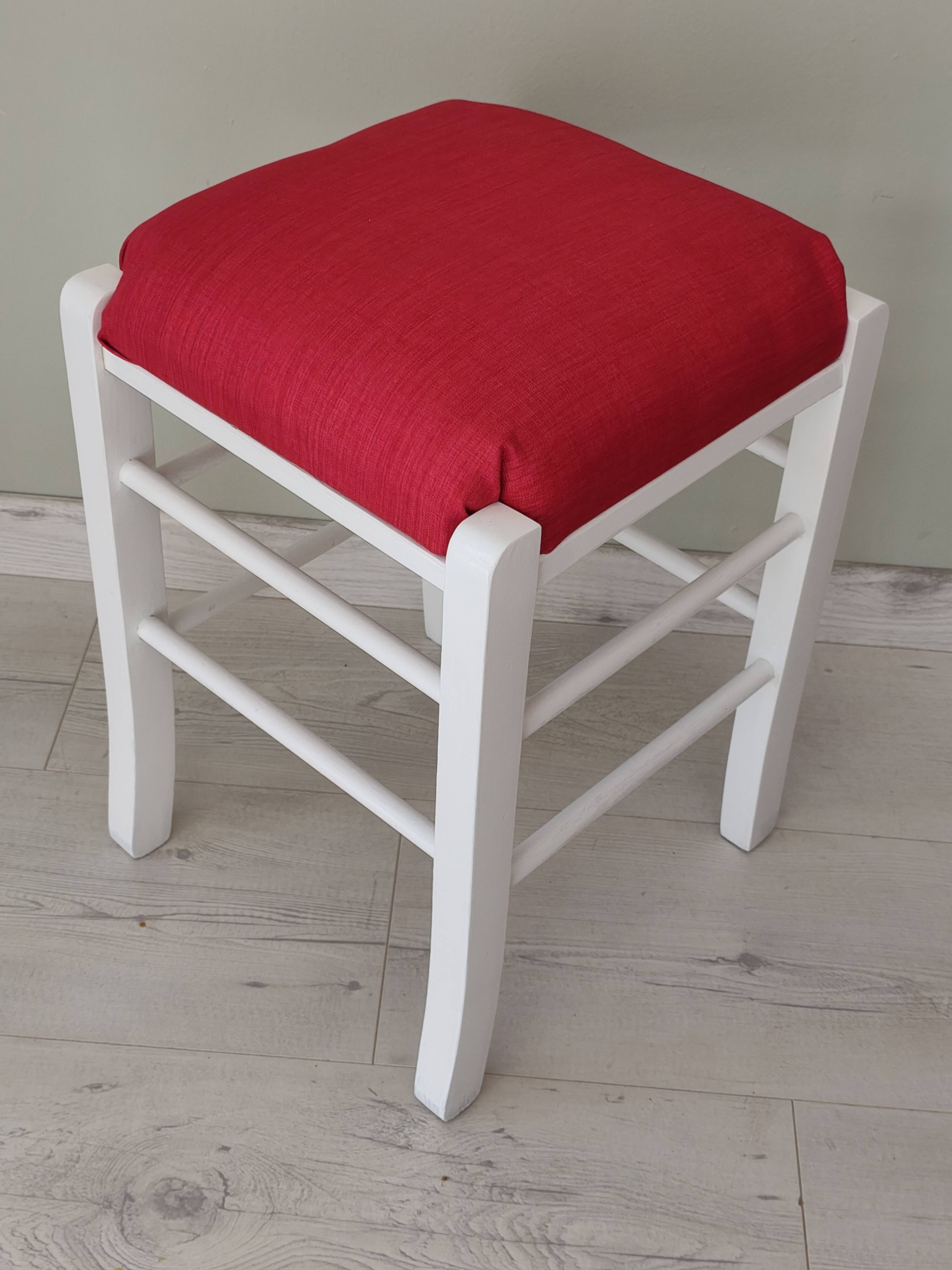 White pine stool with a red seat.