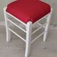 White pine stool with a red seat.