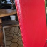 Red leather dining chairs by Arper