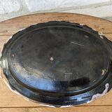 Old oval dish with floral motif called black bottom with staples