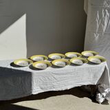 Set of 9 large vintage yellow deep plates with pink flowers and a gold rim.