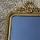 Golden mirror with a pediment from the early 20th century.