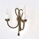 Golden wall lamp with two arms, decorated with a twisted rope bow, 1950s.