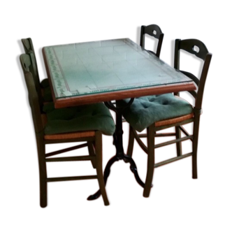 Wrought iron table and craft tiles with its 4 wooden chairs