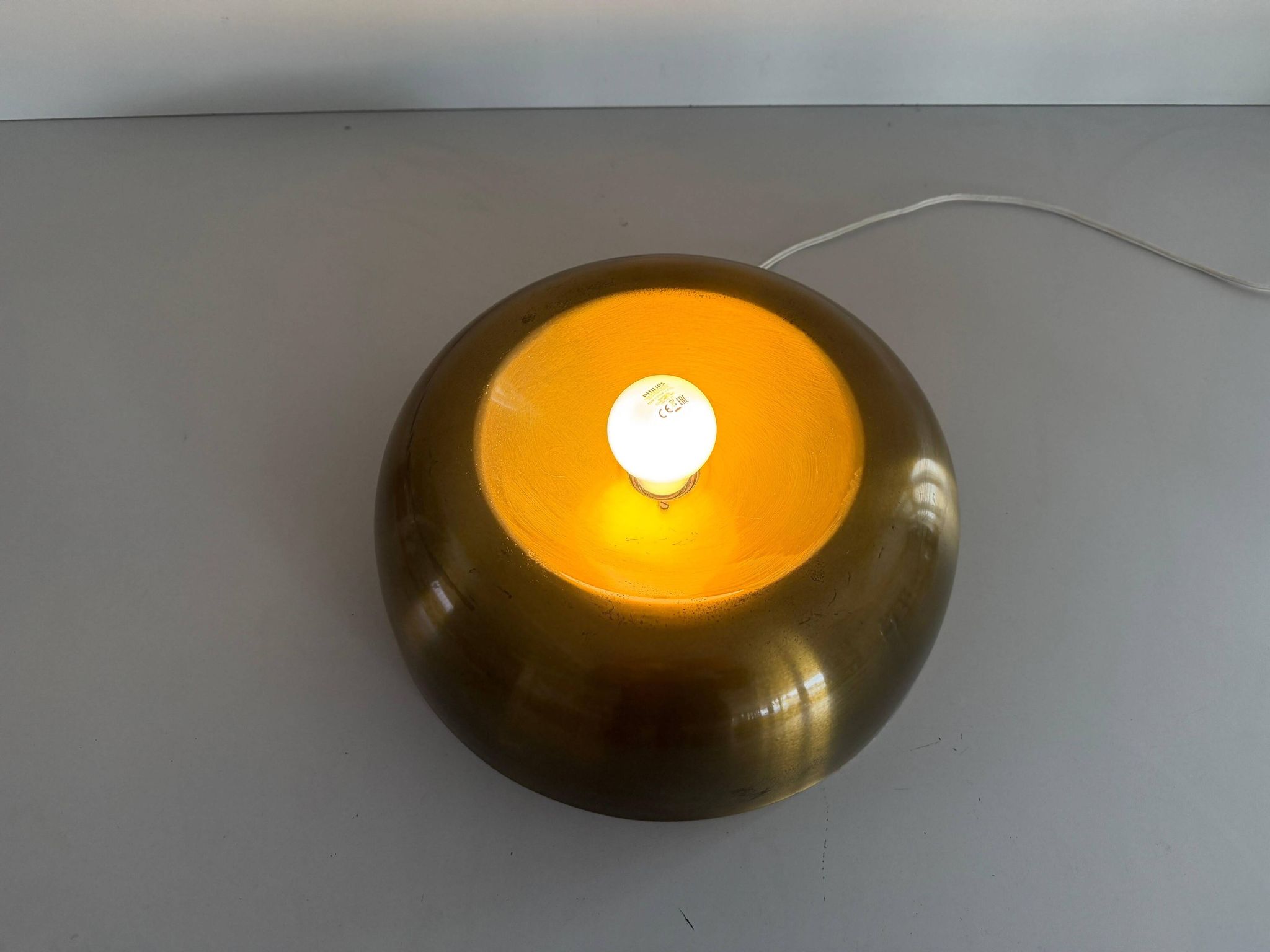 Flush-mounted disc-shaped brass fixture from the mid-century, 1960, Italy.