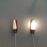 Danish wall lights from the 1970s, made of milky white glass shades, teak wood suspension and brass.