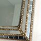 Mirror consisting of multi-faceted mirrors and brass garlands, French work, around 1970