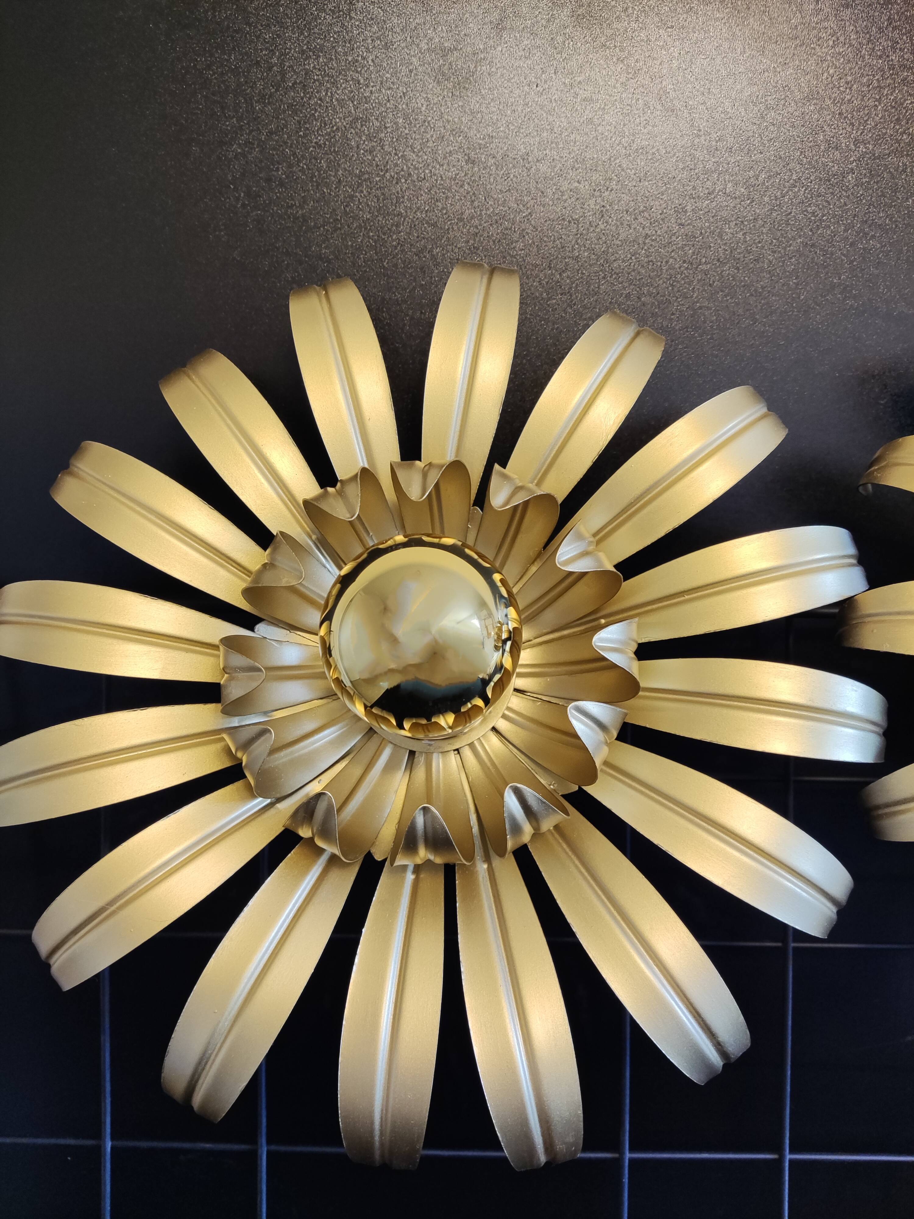 Golden metal flower sconces