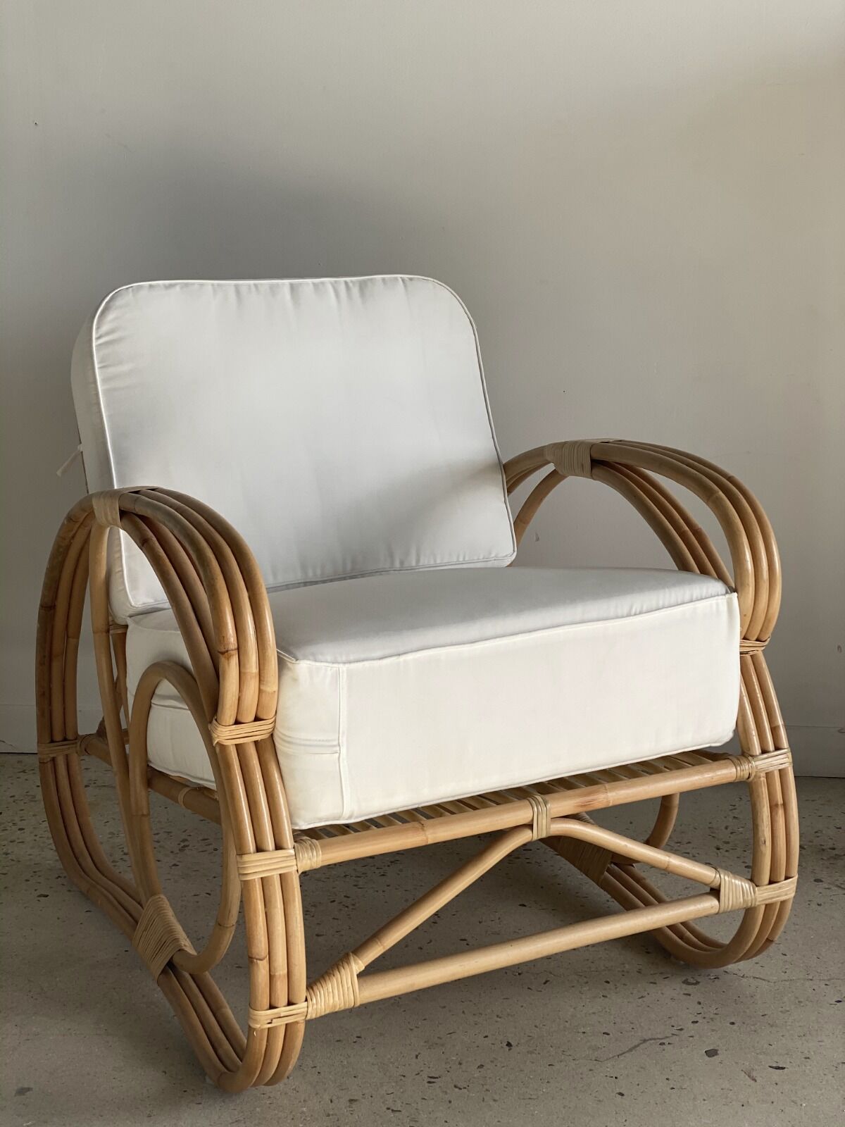Large rattan rest chair and white cushions
