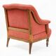 Napoleon III salon armchair in brick red linen with a tufted footrest.